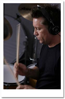 John Clark playing drums in teaching studio